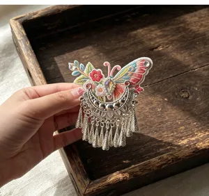 Ethnic embroidered butterfly hair clip with silver tassels, perfect for Hanfu and Cheongsam.