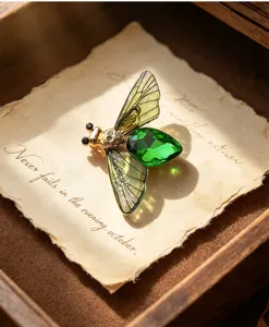 Vintage green crystal cicada insect brooch detail shot with translucent gradient wings.