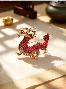 Close-up of a vintage Chinese style dragon brooch, detailed red and white crystal metal design.