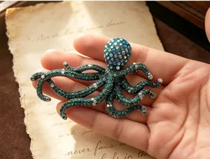 Vintage rhinestone octopus brooch detail shot, sparkling green crystal marine animal pin.