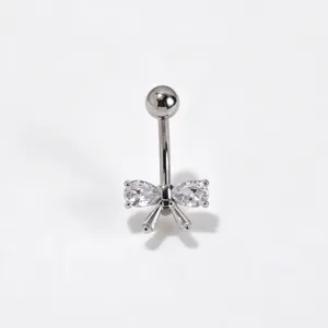 Detailed shot of a stylish stainless steel navel piercing ring with a crystal zircon bow design.