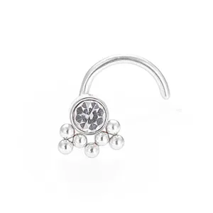 Detailed close-up of a curved 316L stainless steel nose stud with clear zircon and beads.