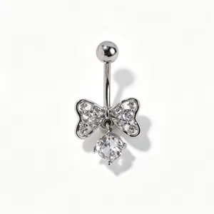 Detailed close-up view of the sparkling cubic zirconia bow navel piercing with crystal detail.