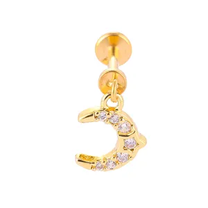 Close-up detail of gold titanium steel labret piercing with pavé zirconia moon charm.