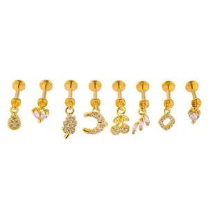 Gold titanium steel labret studs set featuring micro-paved zirconia charms for body piercing.
