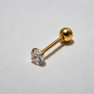 Gold stainless steel barbell body piercing jewelry with sparkling clear cubic zirconia stone.