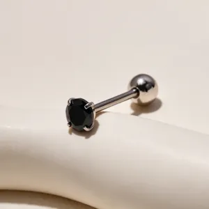Detailed shot of stainless steel tongue piercing with a black cubic zirconia stone and ball.