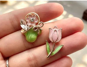 Enamel flower basket and tulip brooch pin details, elegant vintage clothing accessories badge.