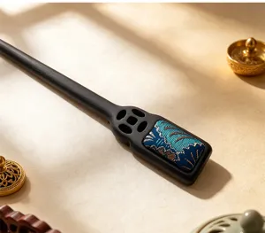 Detailed view of traditional Chinese wooden hair stick with blue brocade inlay and cutout coin.
