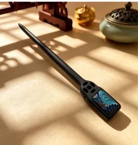 Exquisite details of Chinese style wooden hair stick with blue brocade and cutout design.