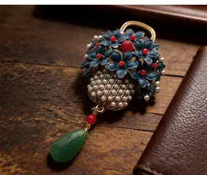 Vintage blue enamel flower basket brooch with pearls and green teardrop tassel pendant.