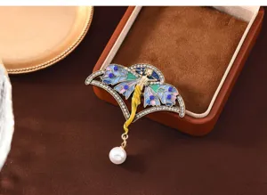 Close-up van vintage emaillen elfje broche met sprankelende kristallen en parel.