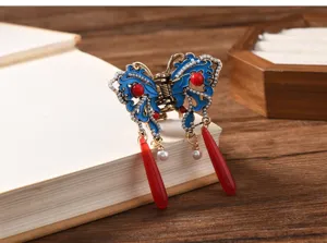 Detail view of a vintage Chinese style butterfly hair claw clip with tassels and pearls.