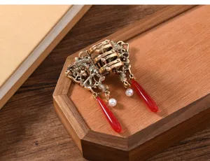 Chinese retro hair claw clip with red tassel and pearl details for elegant daily hairstyles