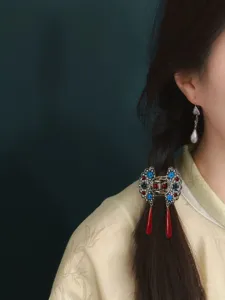 Detailed view of traditional Chinese style butterfly hair claw clip with elegant tassels.