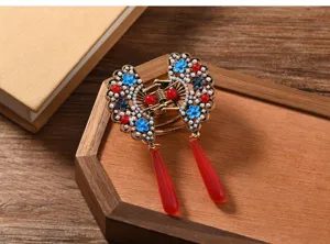 Close-up detail of vintage Chinese style butterfly hair claw clip with elegant red tassels.