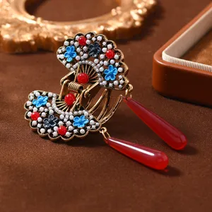 Traditional Chinese retro hair claw clip with fan-shaped design, pearls, and red tassels.