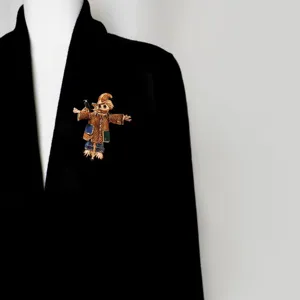 Vintage enamel scarecrow brooch detail view, retro lapel pin accessory for coats and jackets.
