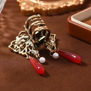 Vintage Chinese style hair claw clip with pearl tassel and red teardrop charms for elegant women.