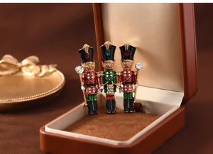 Vintage enamel nutcracker soldier brooch set with sparkling rhinestones for coat jackets.