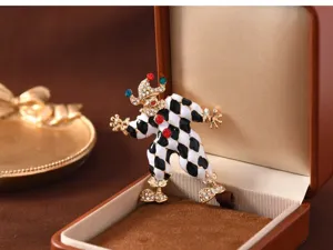 Vintage black and white enamel clown brooch featuring sparkling rhinestones and colorful gems.