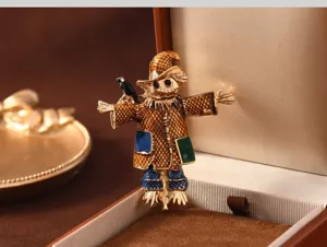 Vintage enamel scarecrow brooch detailed shot, retro metal pin badge for coat sweater decor.