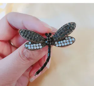Detailed view of the rhinestone dragonfly brooch, exquisite insect enamel pin for women.