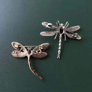 Detail shot showing the secure pin back and textured alloy craft of the elegant dragonfly brooch.