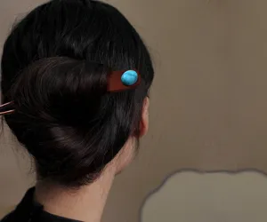 Exquisite red sandalwood hair fork with turquoise stone detail for elegant daily hair styling.