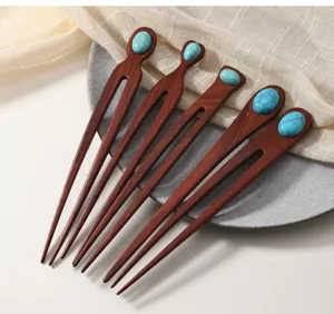 Detail view of red sandalwood hairpin with turquoise decoration, elegant daily hair styling accessory.