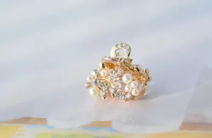 Mini pearl rhinestone flower hair claw clip, elegant gold metal hair accessory for daily styling.