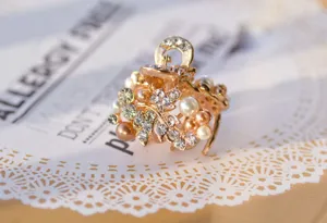 Pearl and rhinestone mini hair claw clip detail, exquisite gold floral design for women hair.