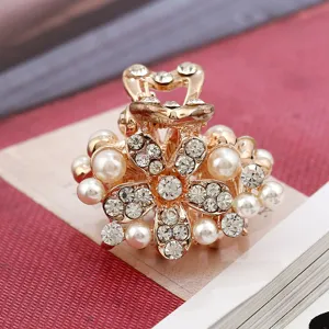 Mini pearl rhinestone hair claw clip, golden metal flower design for women and girls daily use.