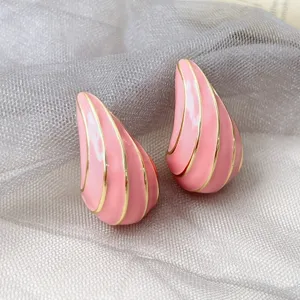 Nahaufnahme Detail der rosa Emailliertropfen Ohrringe mit eleganten goldenen Linien.