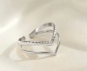 Detailed shot of a silver double layer open ring with woven texture and minimalist design.