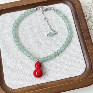 Green aventurine bead bracelet with red gourd pendant, elegant minimalist Chinese style jewelry.