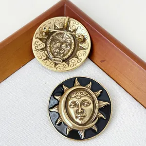 Vintage celestial sun and moon face brooch, creative metal enamel badge for coat and bag.
