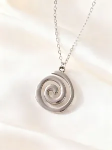 Stainless steel swirl geometric pendant necklace detail, minimalist fashion jewelry design.