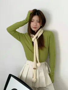 Koreanischer Strick langer schmaler Schal Detail, weiche Bommel-Akzente, trendiger Baguette-Stil.