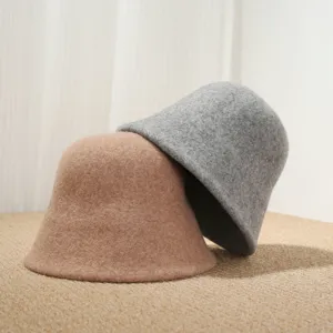 Detail shot of cozy wool bucket hats in grey and brown, showing soft felt texture and warm design.