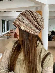 Close-up detail of a retro striped knit beanie hat showcasing comfortable texture style.