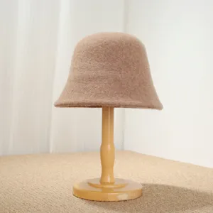 Detailed view of cozy wool bucket hat in camel, soft texture and vintage basin design.