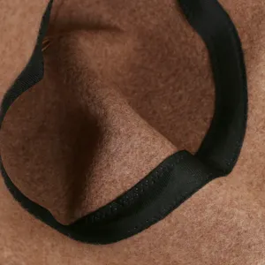Close-up detail of the wool hat interior, featuring soft felt texture and black ribbed trim.