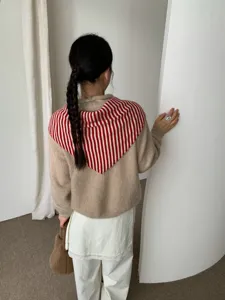 Winter pure wool knitted sweater with red and white striped scarf shawl, stylish back view detail.