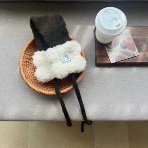Plush winter earmuffs with cute strap design, warm and cozy ear warmer for women daily wear.