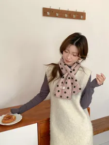 Cozy pink knitted patterned neck scarf detail, elegant winter accessory for women style.