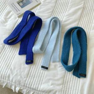 Knitted narrow scarf detail, solid color woolen neck wrap, cozy winter accessory style.