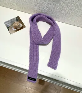 Solid purple knitted baguette scarf, cozy wool winter neck warmer, soft retro fashion accessory.