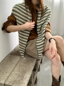 Striped knitted triangular scarf shawl for women, trendy autumn winter fashion accessory.