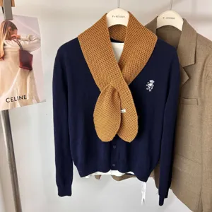 Vue détaillée de l'écharpe en tricot de laine et du cardigan bleu marine d'automne.